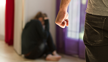 A man faces a woman, suggesting a discussion